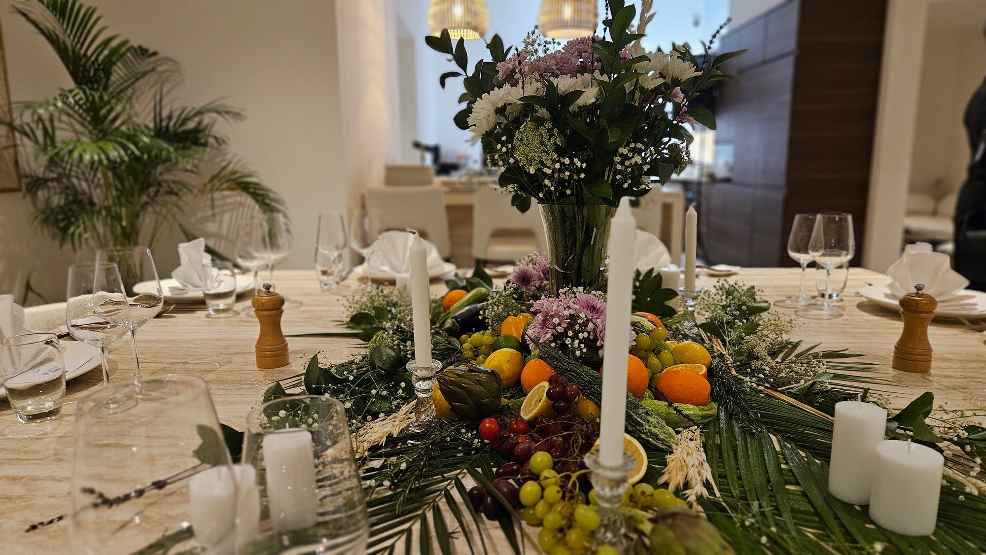Long table dressed in white linen and candlelight in a Dubai villa.