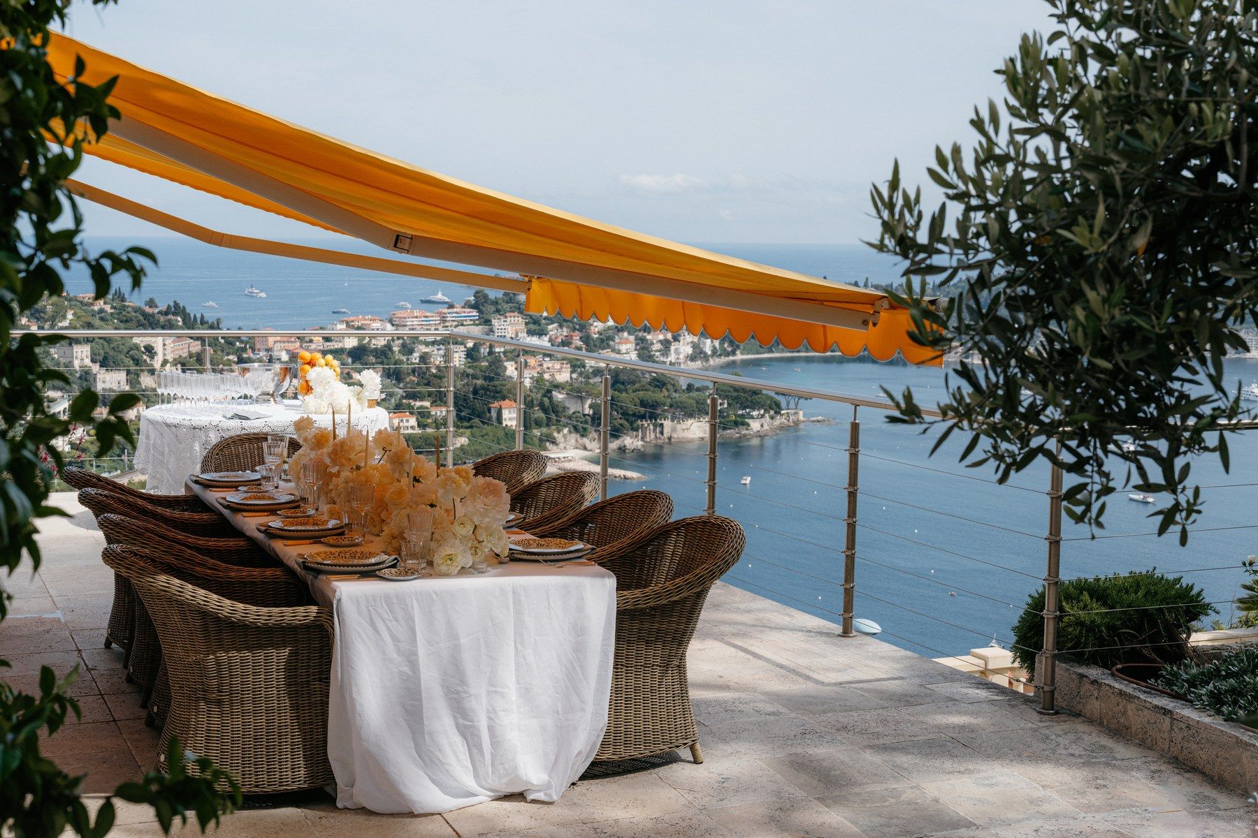 Tablescape dressed with white blooms above the Mediterranean.